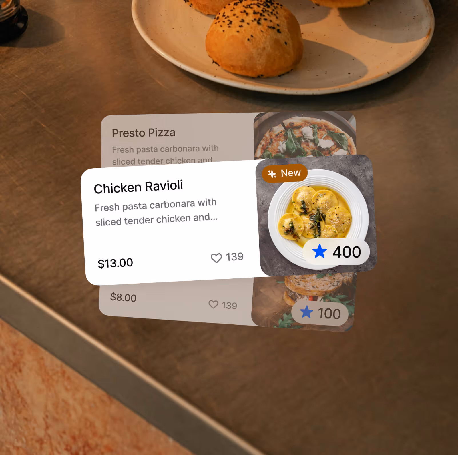 Digital menu cards displaying Chicken Ravioli with price $13.00, 139 likes, and 400 points on a background of a plate with bread rolls.