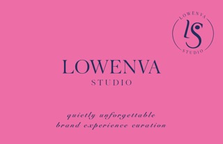 Six people standing in front of a large wooden sculpture of an animal resembling a fox in a green forest.