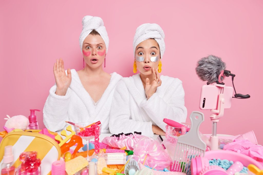 Deux femmes entrain de se filmer testant des produits de beauté