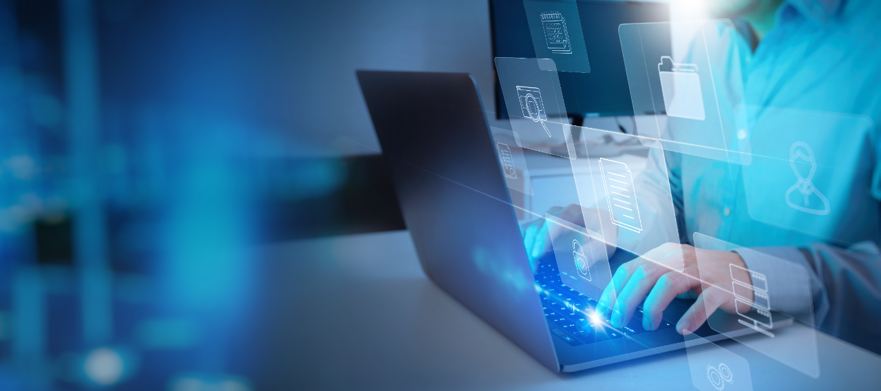 Person typing on a laptop with holographic digital icons representing files and user profiles floating above the keyboard.