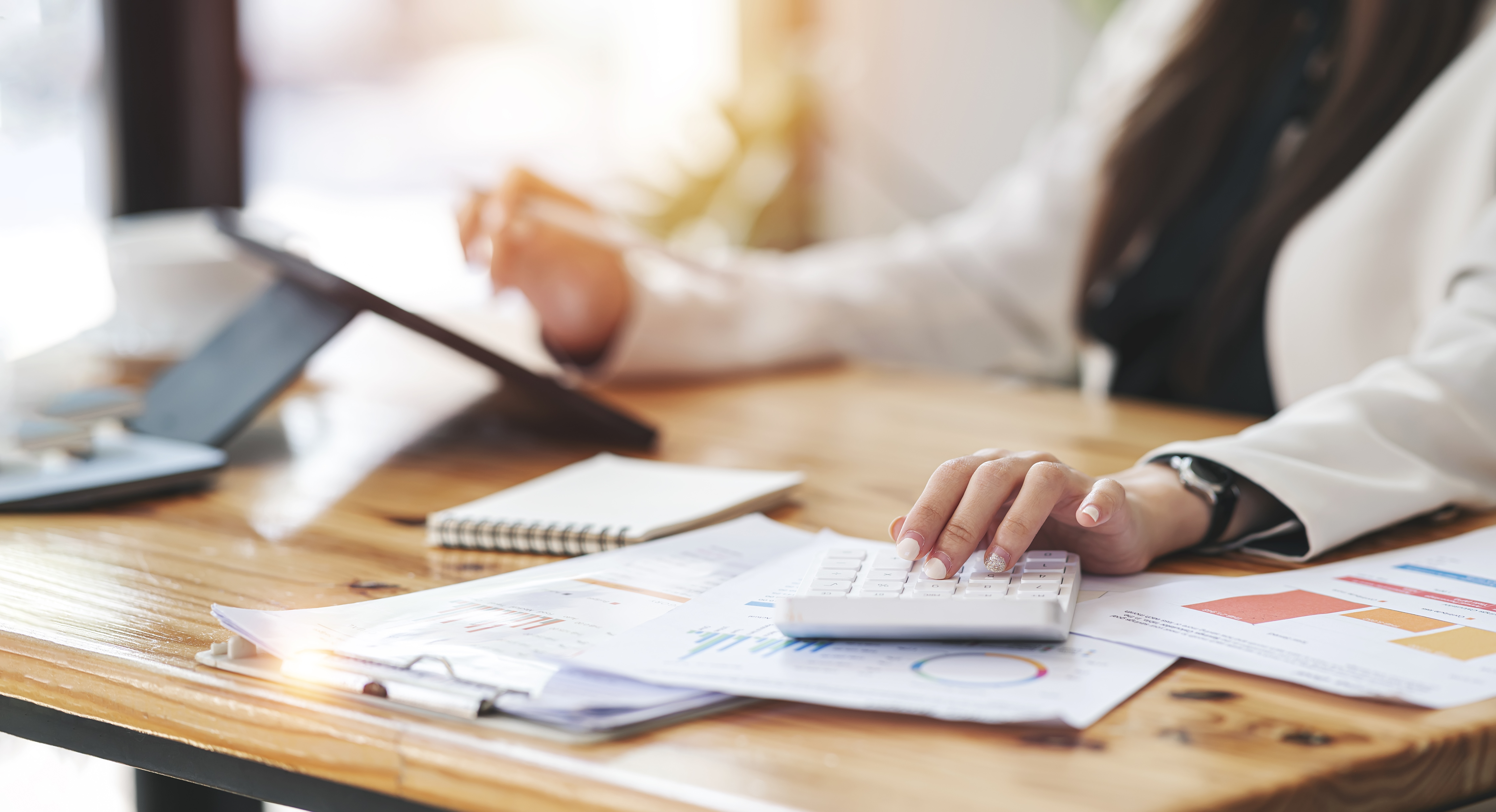 Businesswoman reviewing employee benefits and insurance documents at her desk