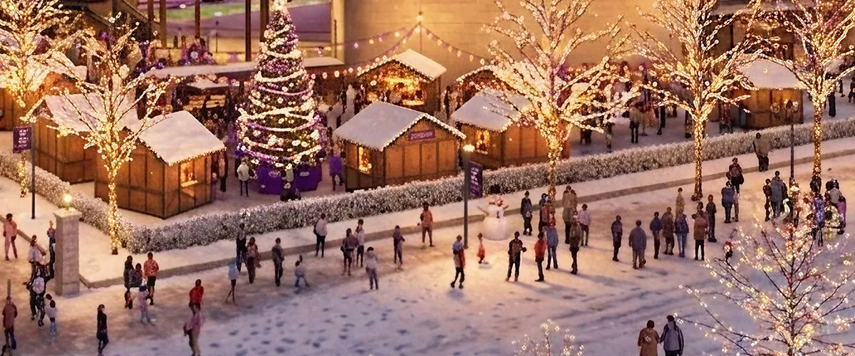 Holiday stalls and a lit tree on the plaza at New Ryan Field