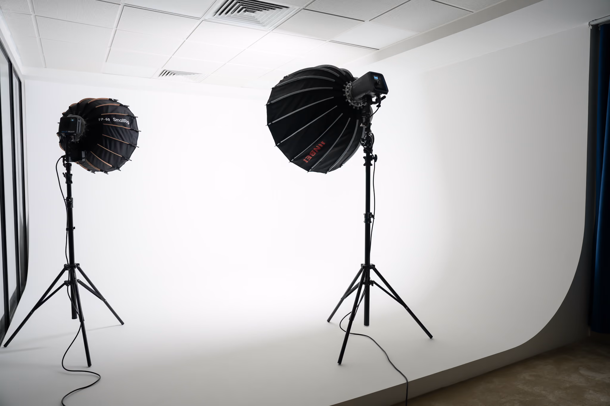 A plain white cyclorama for photography and videography with 2 headlights lighting it