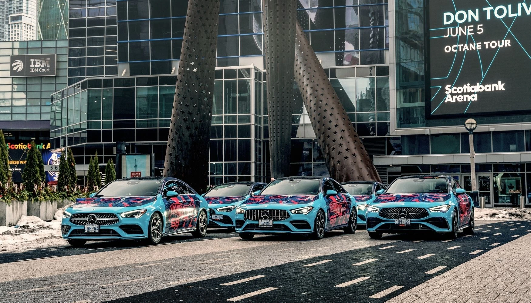 Fleet of wrapped vehicles parked on the side of the road
