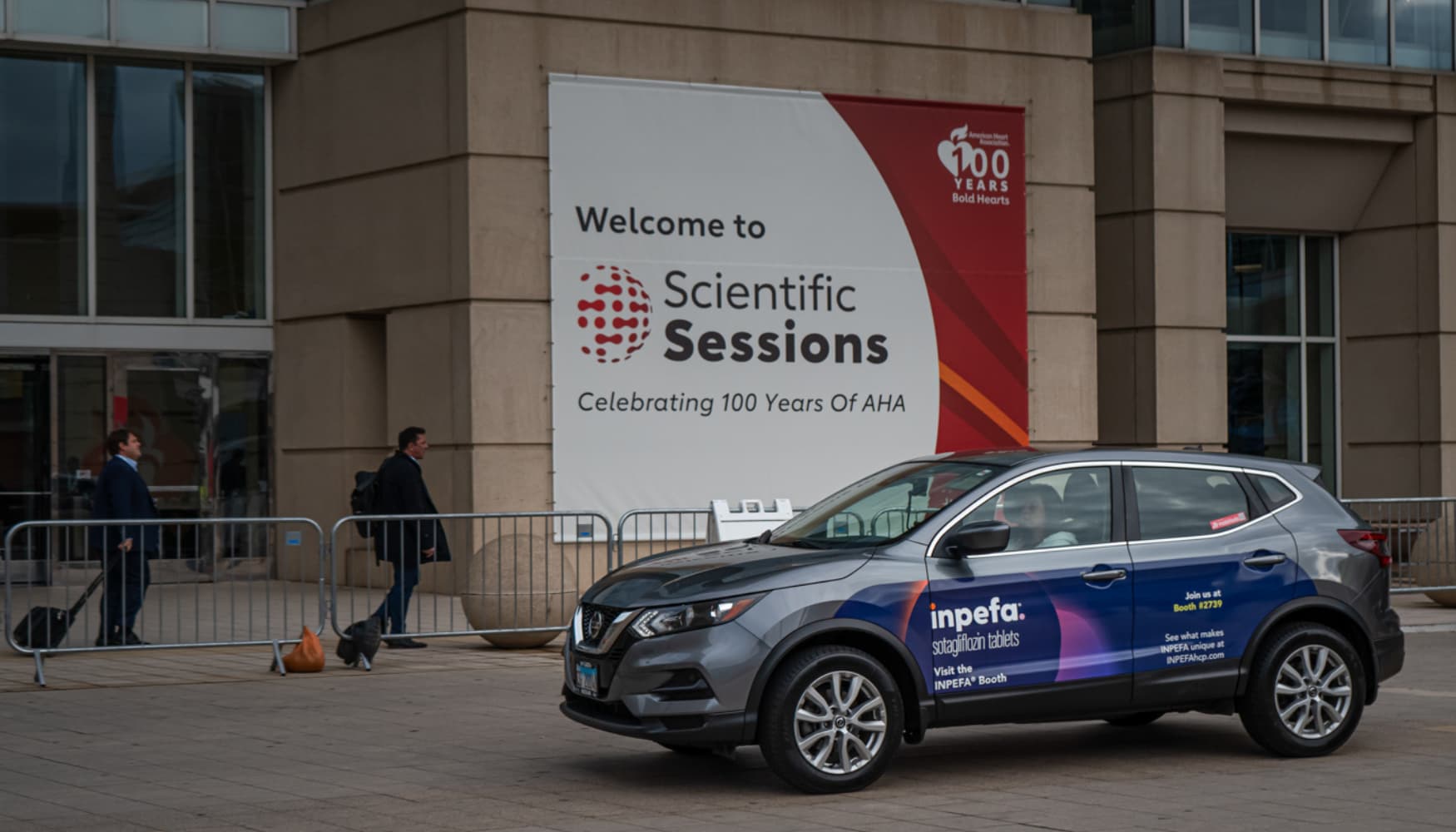 Wrapped vehicle driving past a medical conference