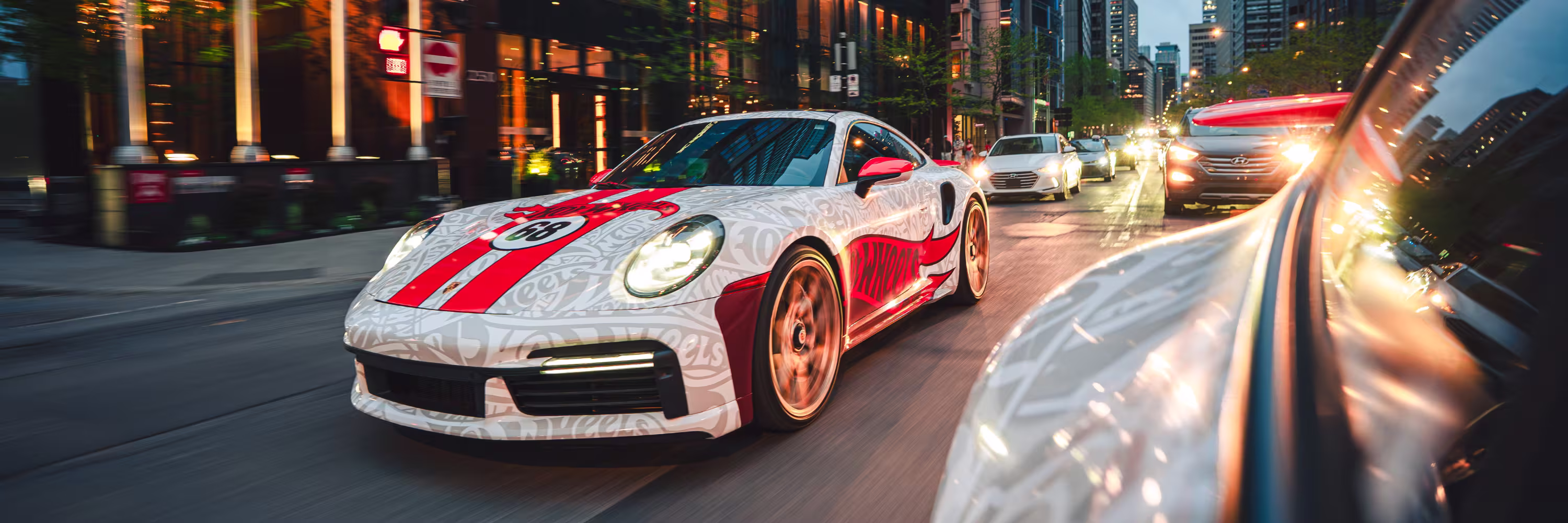 Hot Wheels wrapped Porsche 911 driving through a busy street