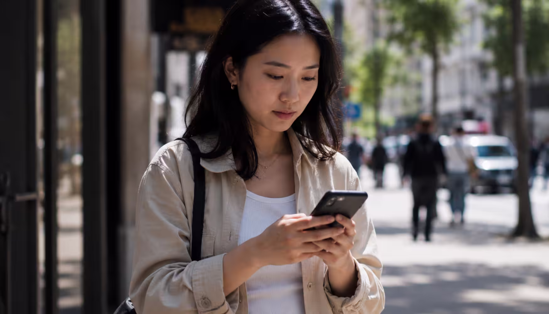 Asian woman researching something on her phone