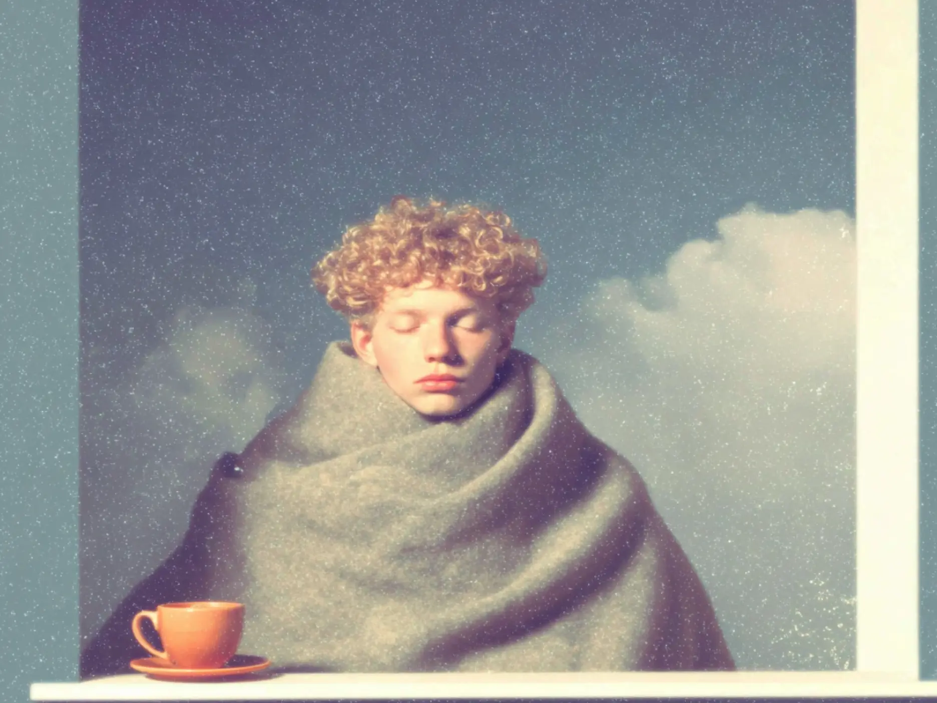 A drawing of a person in a cosy blanket with tea cup by their side.