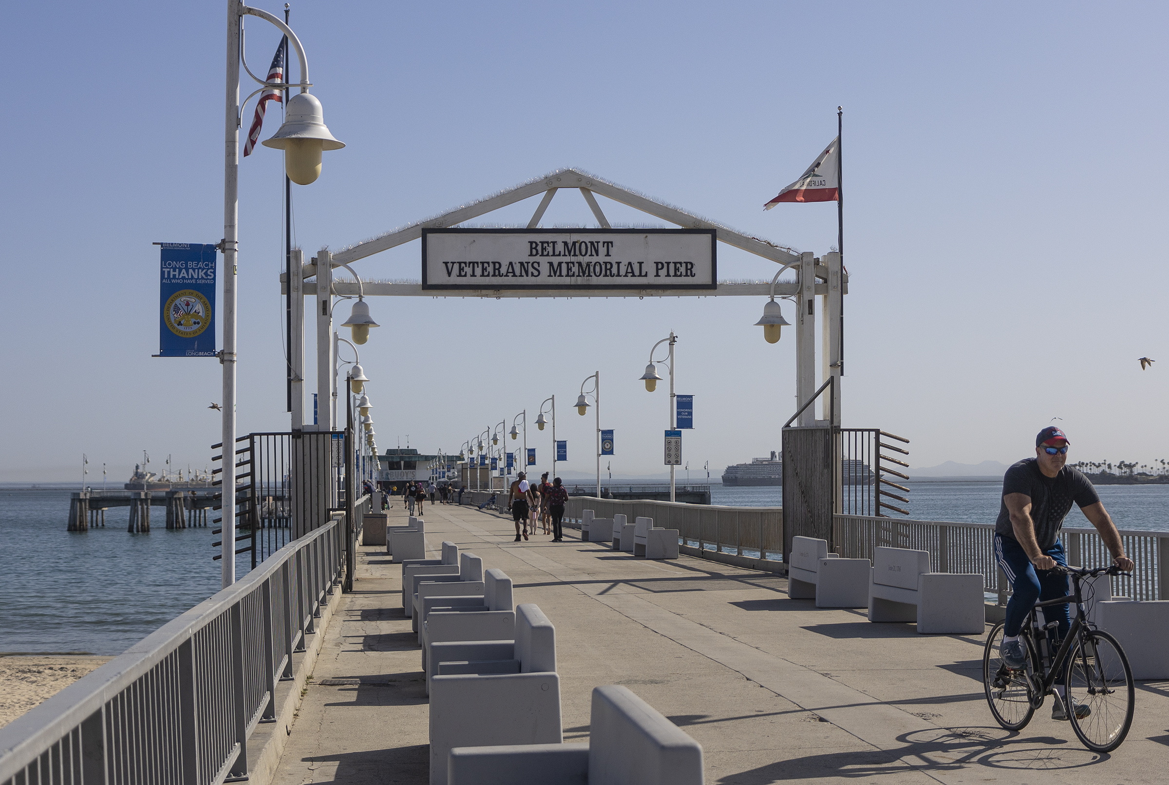 belmont pier at long beach, including sign and biker