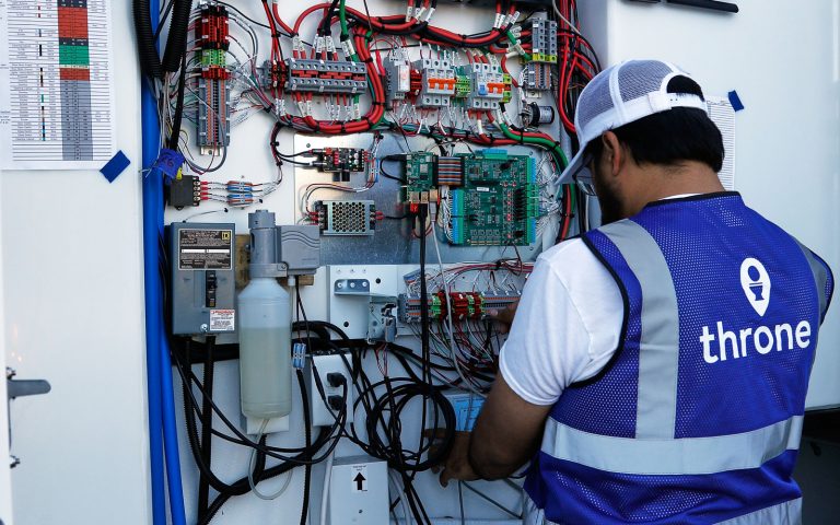 long beach technician daniel working on the electric panel of a throne