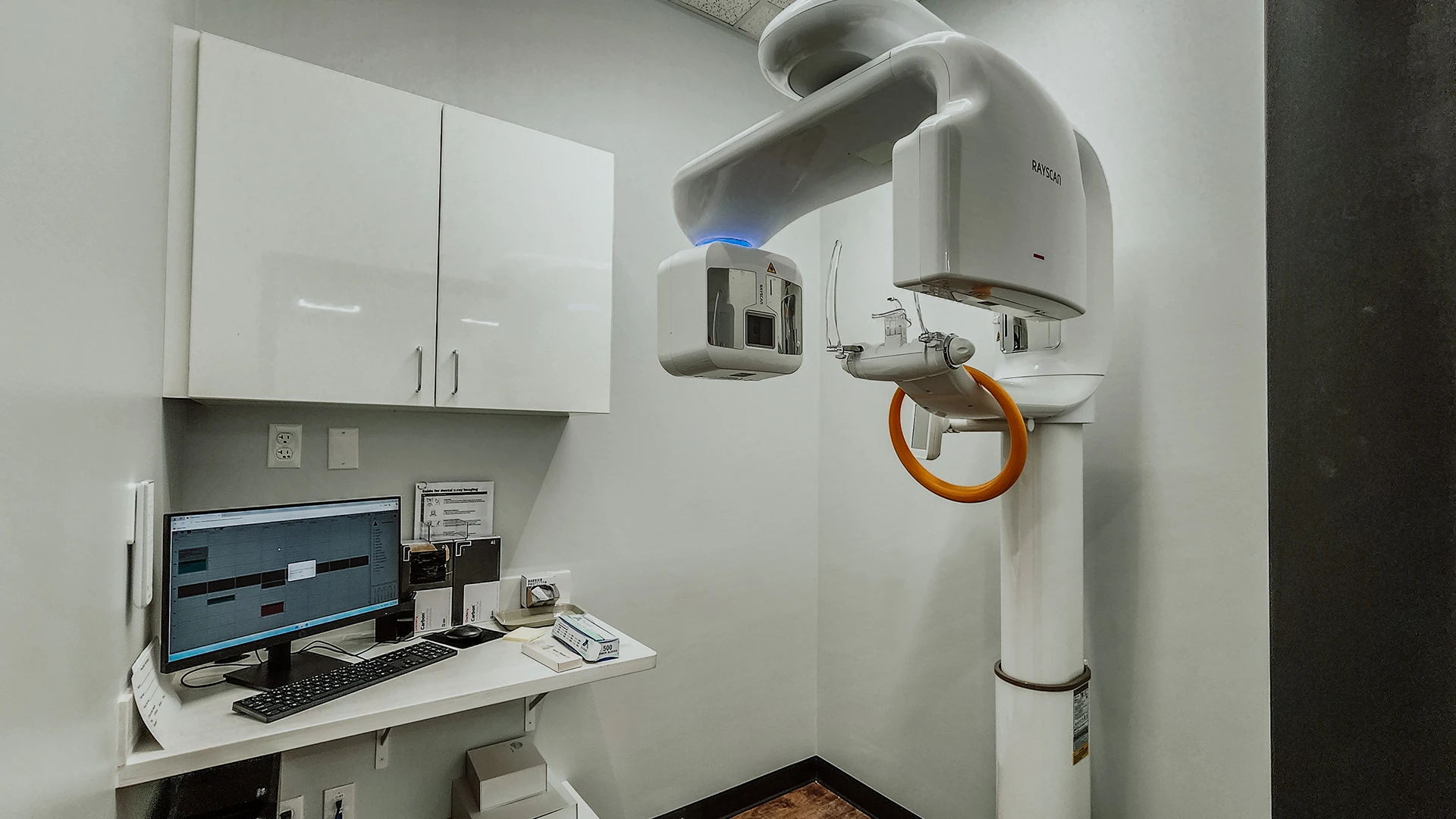 a dental xray machine in a white room.