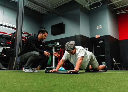 Patient working with a provider at a performance physical therapy clinic in Mount Pleasant, SC during force plate testing