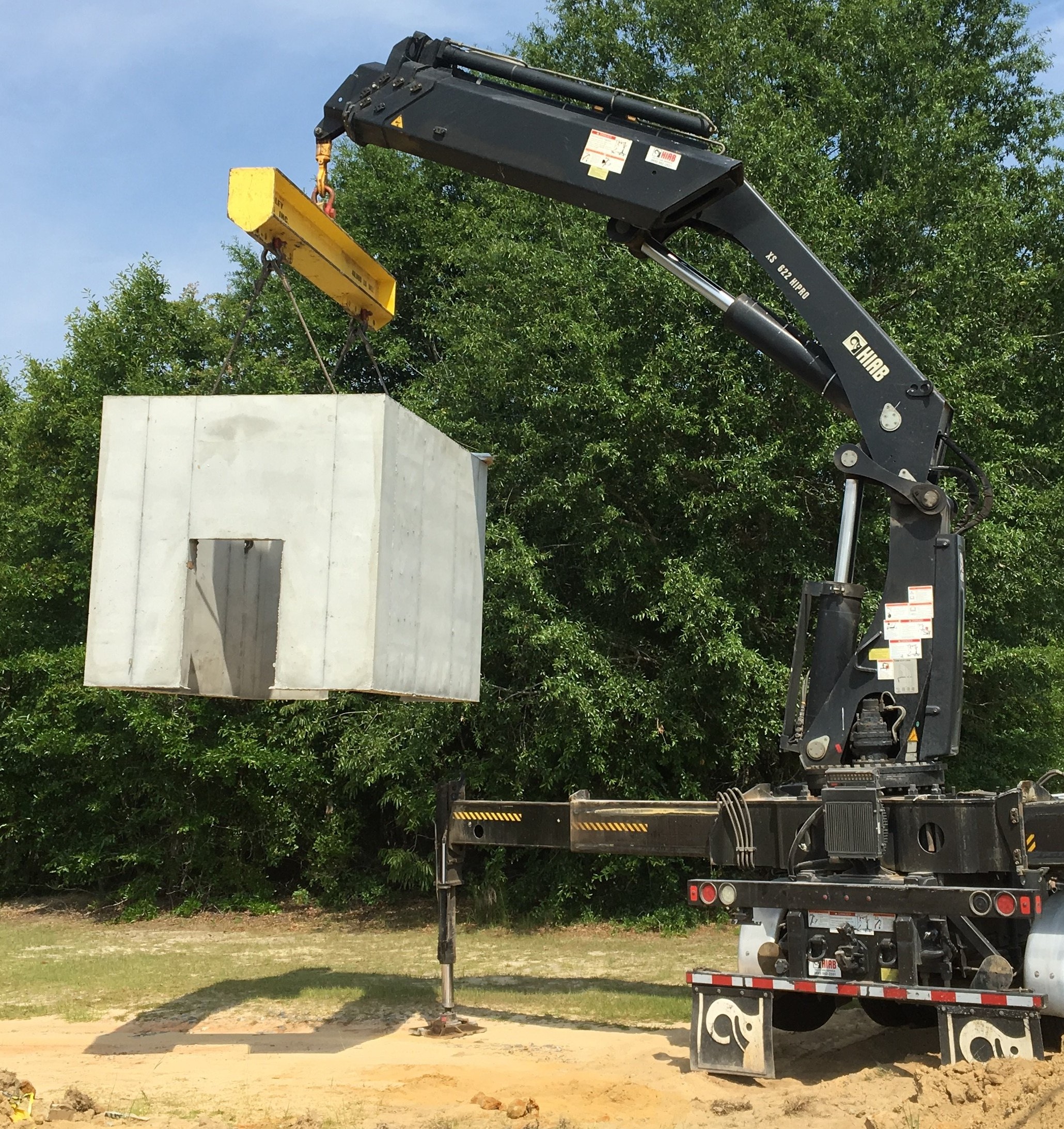 M&E Construction utility construction crew setting a concrete structure