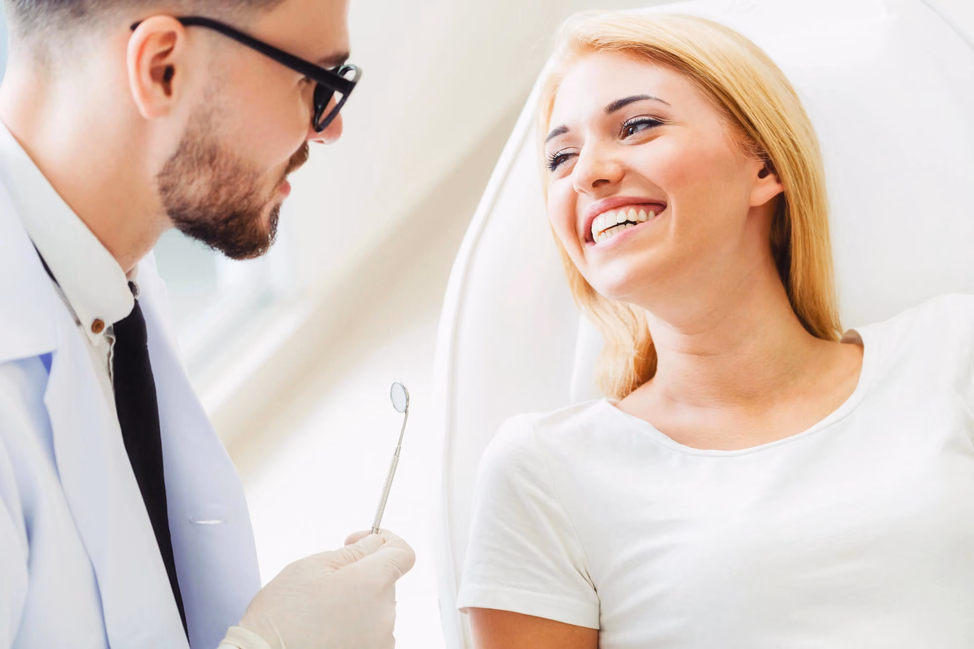 female patient smiling at her dentist