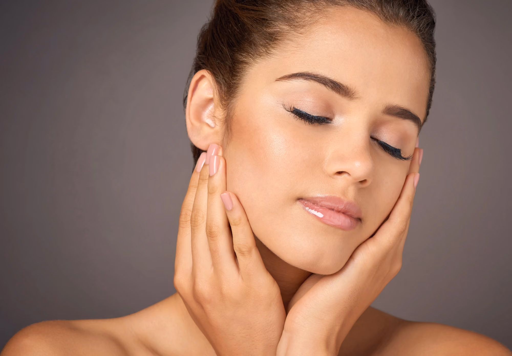 relaxed woman touching her face