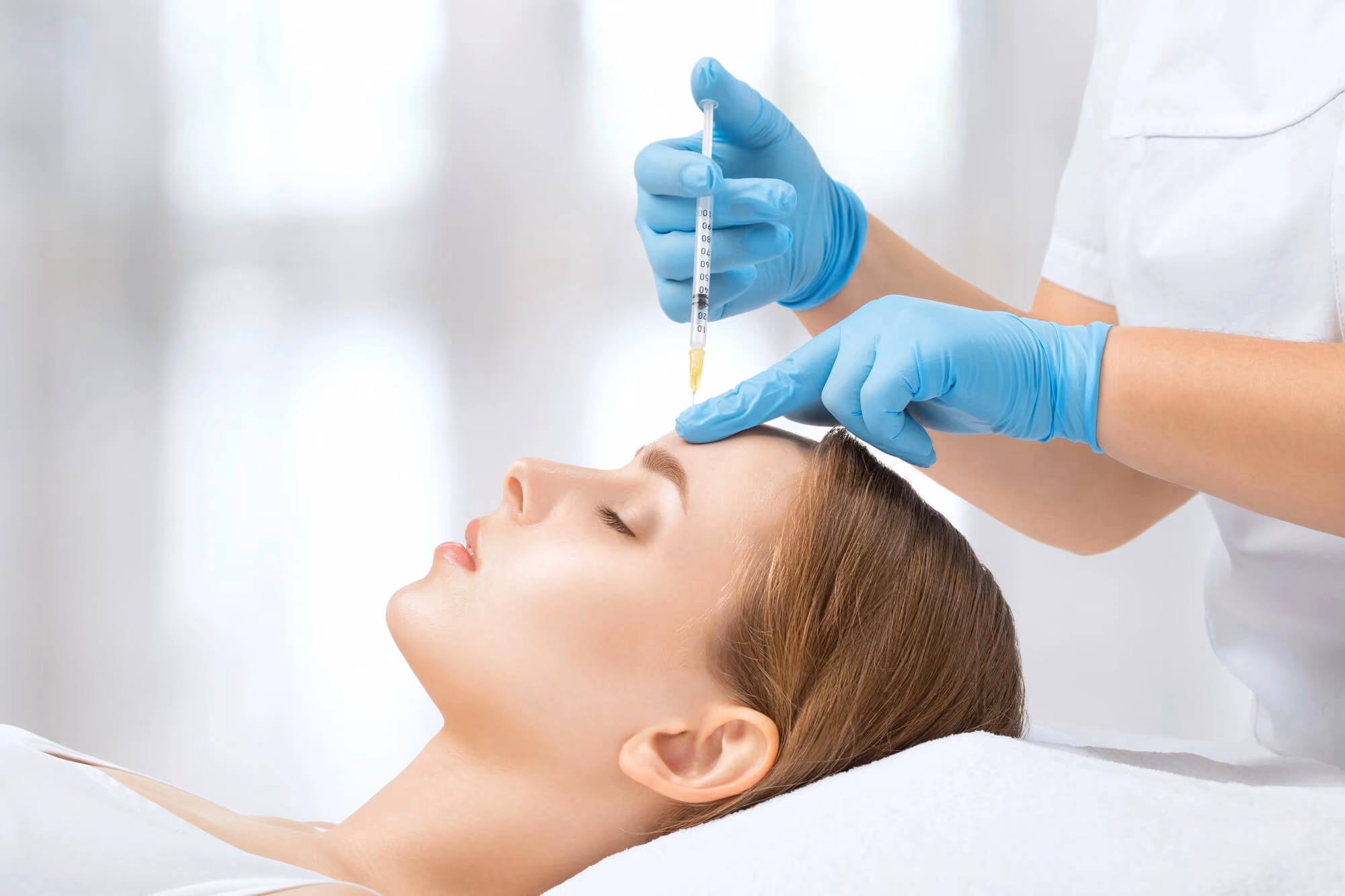 woman getting injections on her forehead