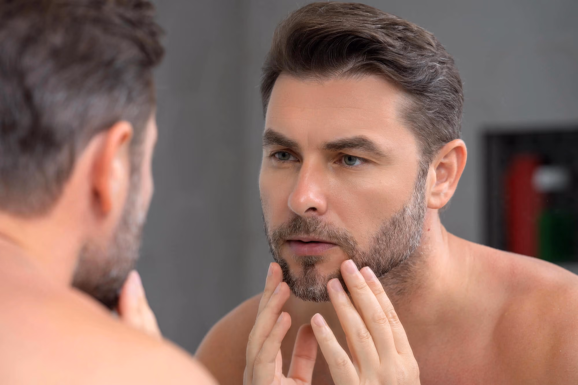 Man checking face in mirror