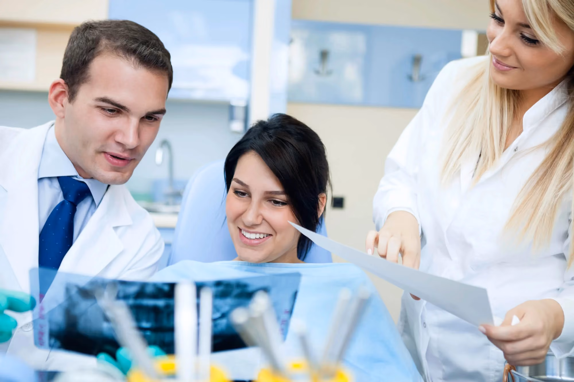 Patient reviewing x-rays with dentists