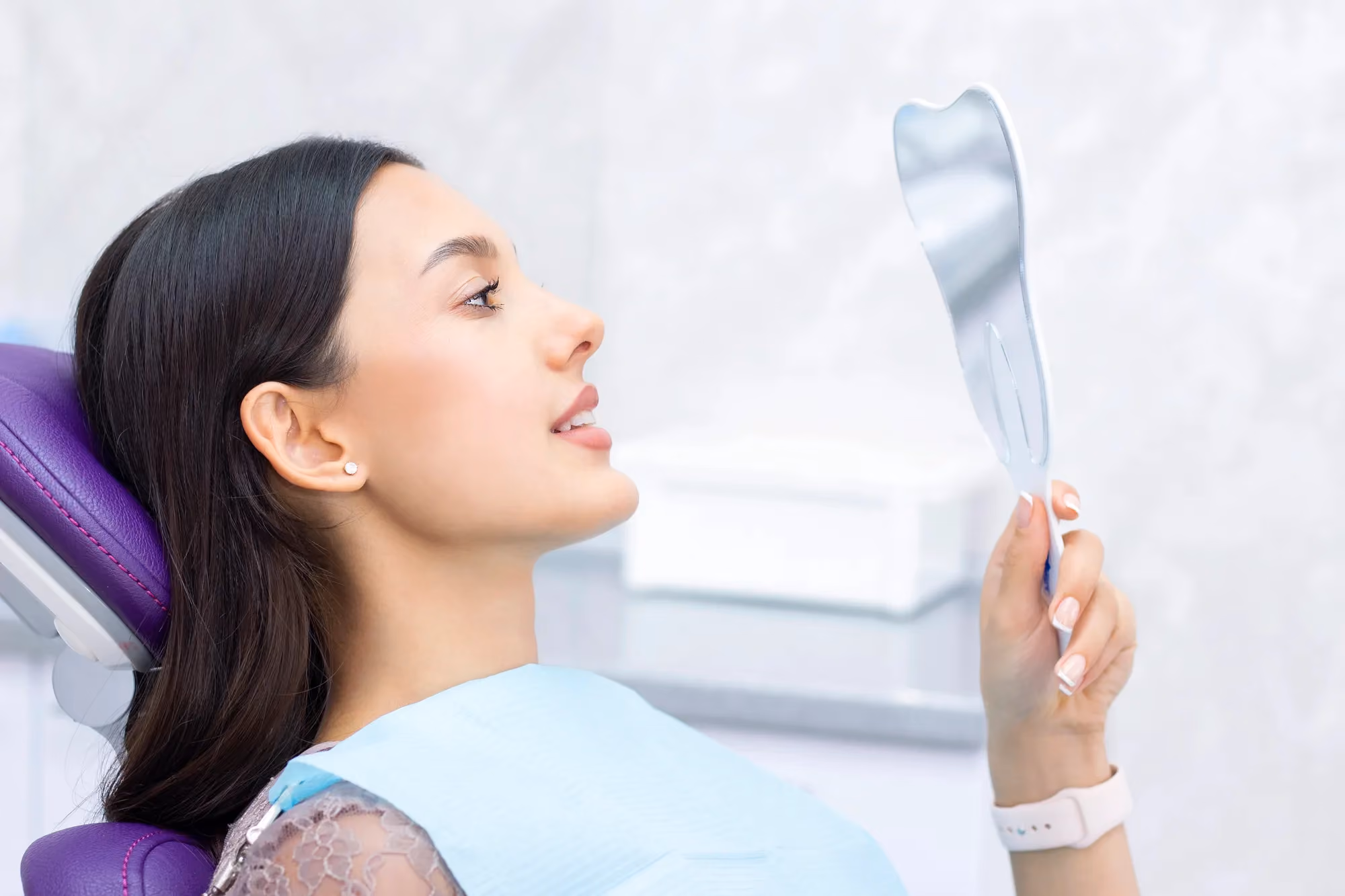 Woman looking at mirror smiling