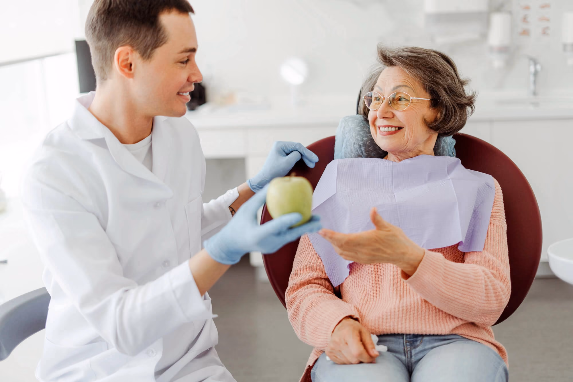 Dentist talking with female patient