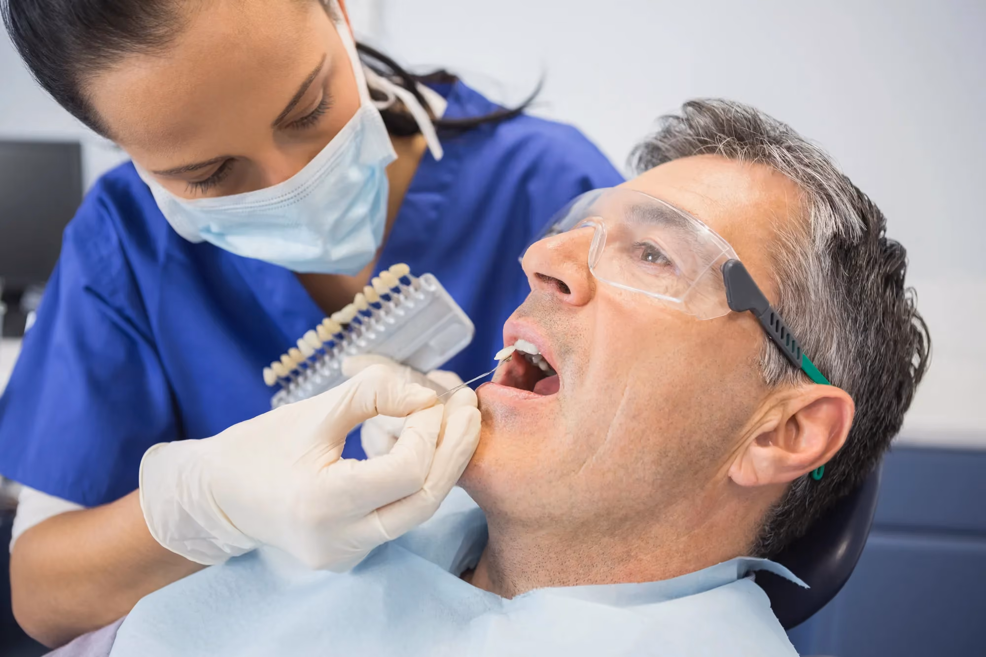 man picking tooth shade