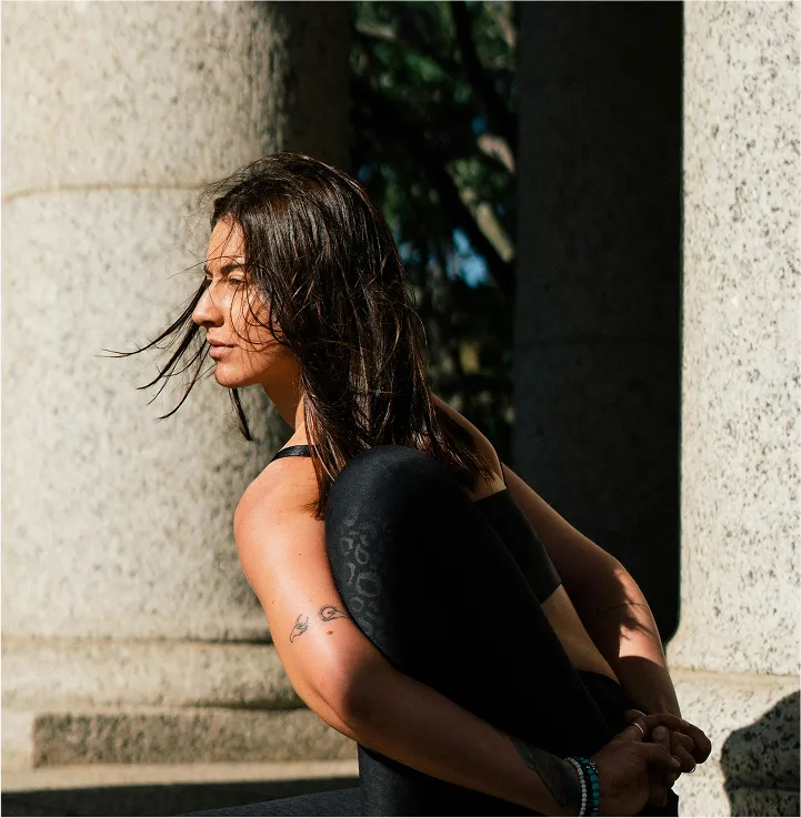 Three women smiling in yoga outfits