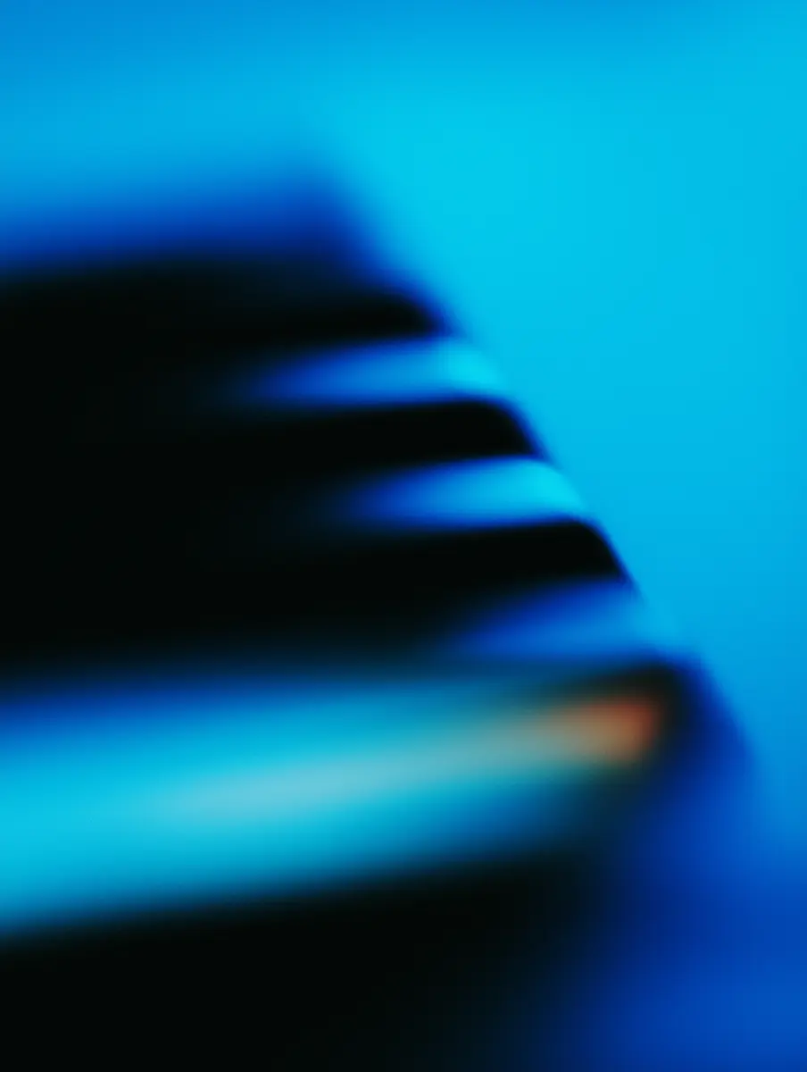Abstract close-up of a blue and black gradient with soft horizontal streaks on a blue background.