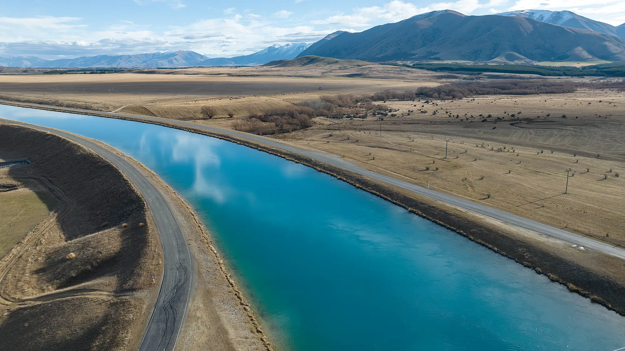 Photo of Twizel Canal and mountains in the background.
