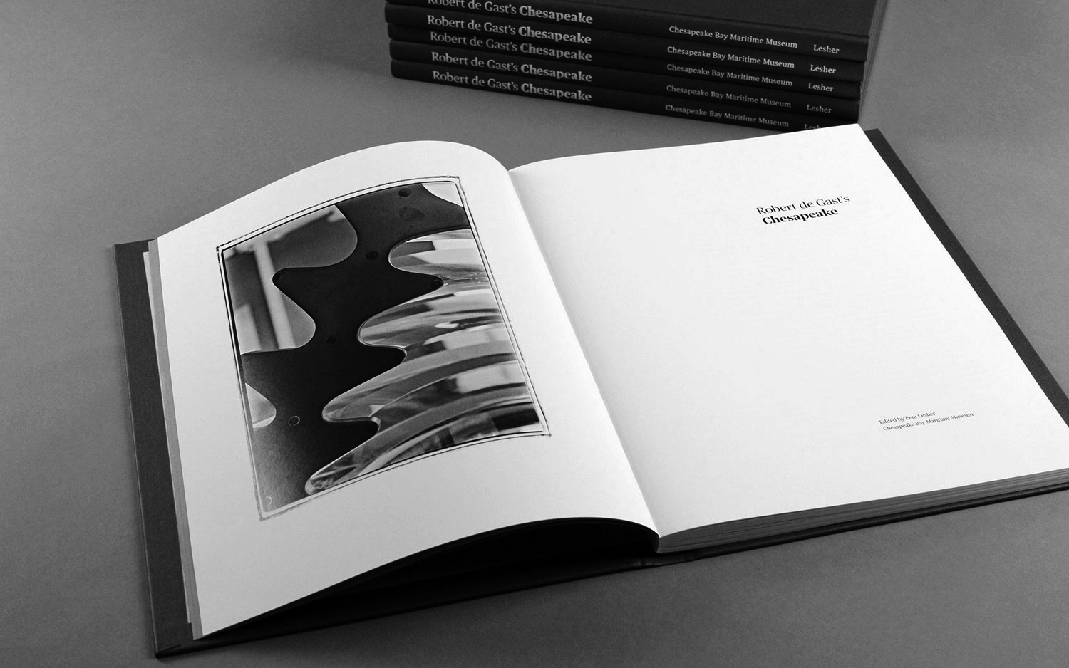 stack of books next to open bookto title page