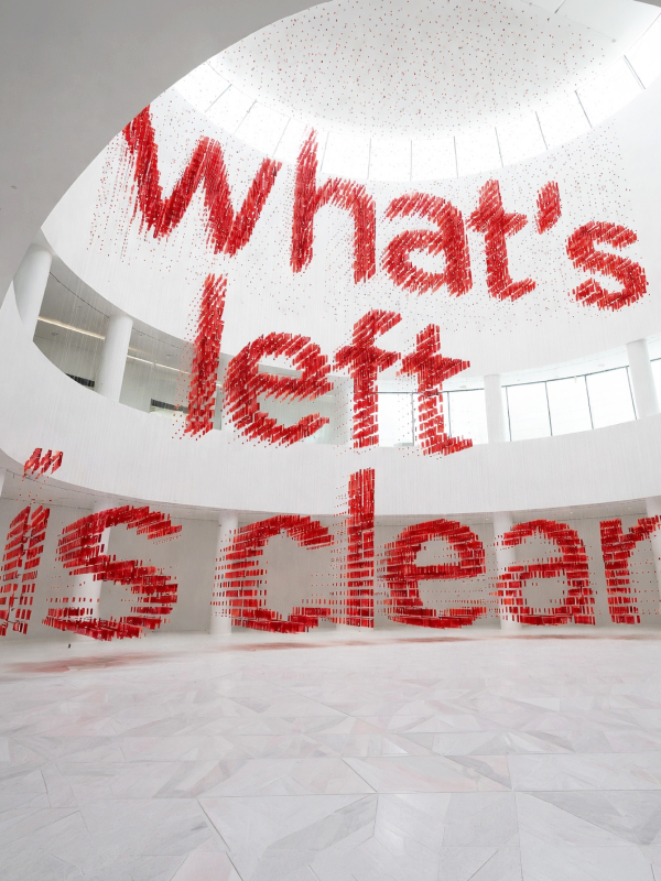 A hand pulling a bottle of Fizz Kombucha out of the pack.
