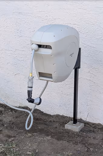 Outdoor wall-mounted retractable garden hose reel - providing professional handyman services in Simi Valley.
