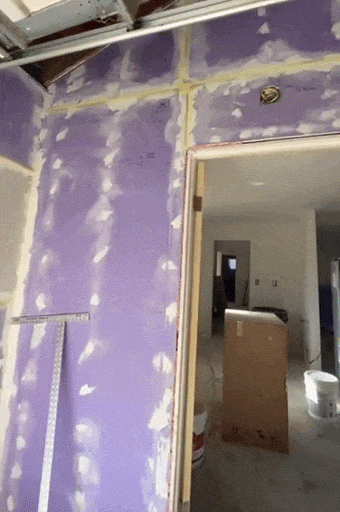 Interior wall under construction with drywall panels and joint compound applied around seams and screws - Providing professional handyman services and home repairs in Simi Valley.