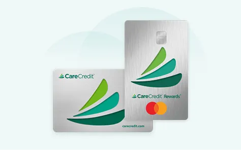 Two CareCredit cards with silver backgrounds, green and teal swoosh logo, and one card featuring Mastercard logo.