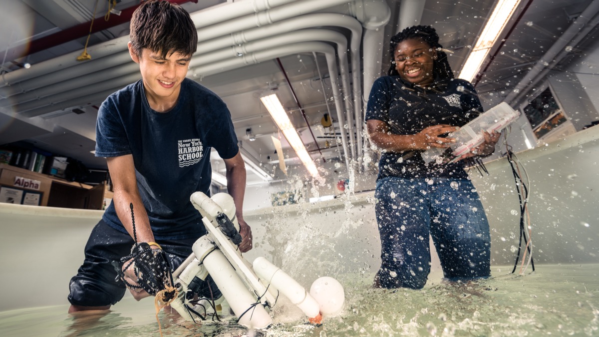 Harbor School students testing an underwater robot in an indoor tank