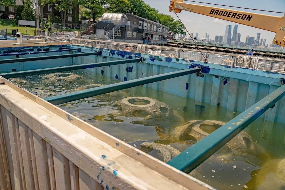 Setting tanks holding submerged reef structures where oyster larvae attach to shells