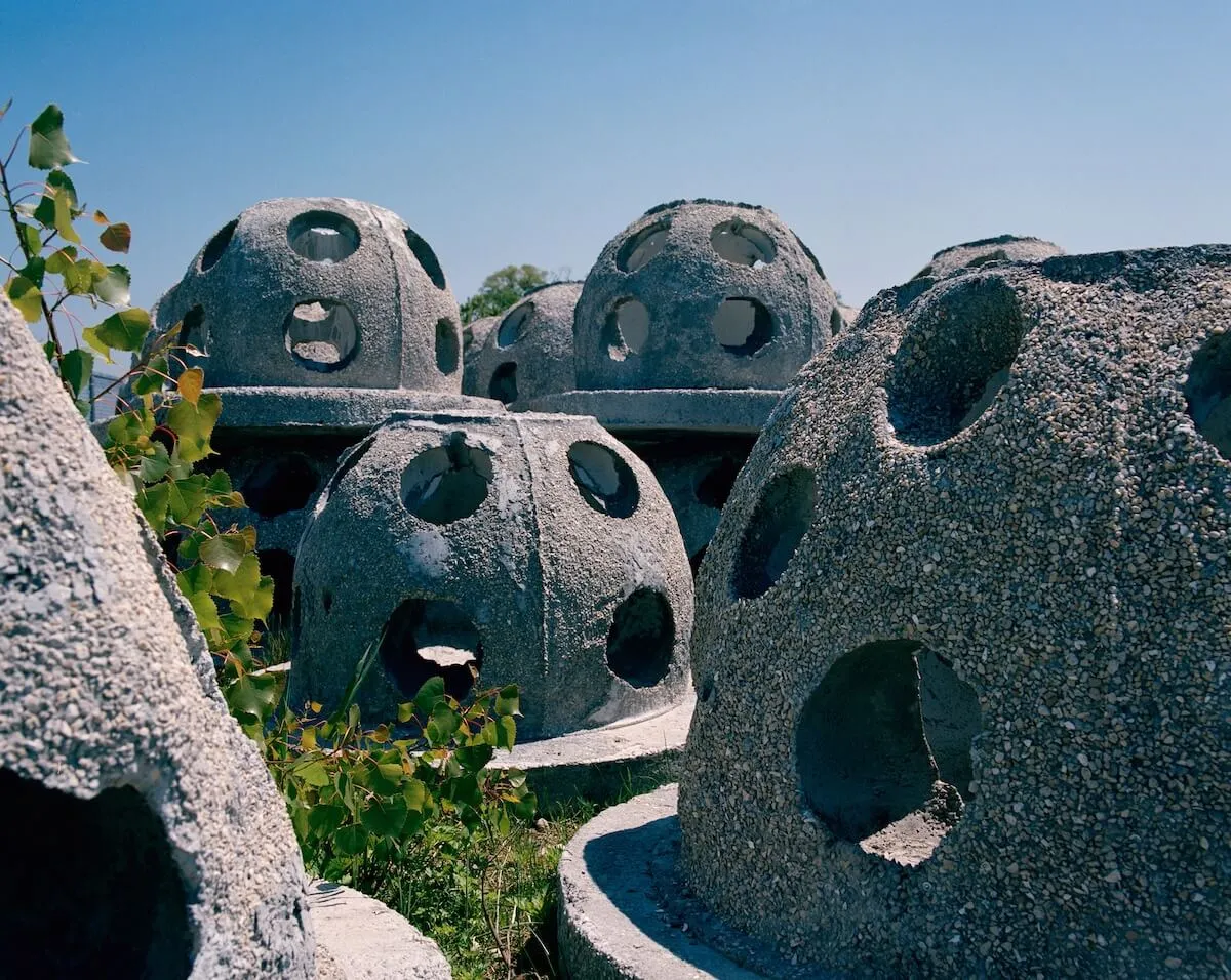 Perforated concrete reef ball domes staged on land before installation