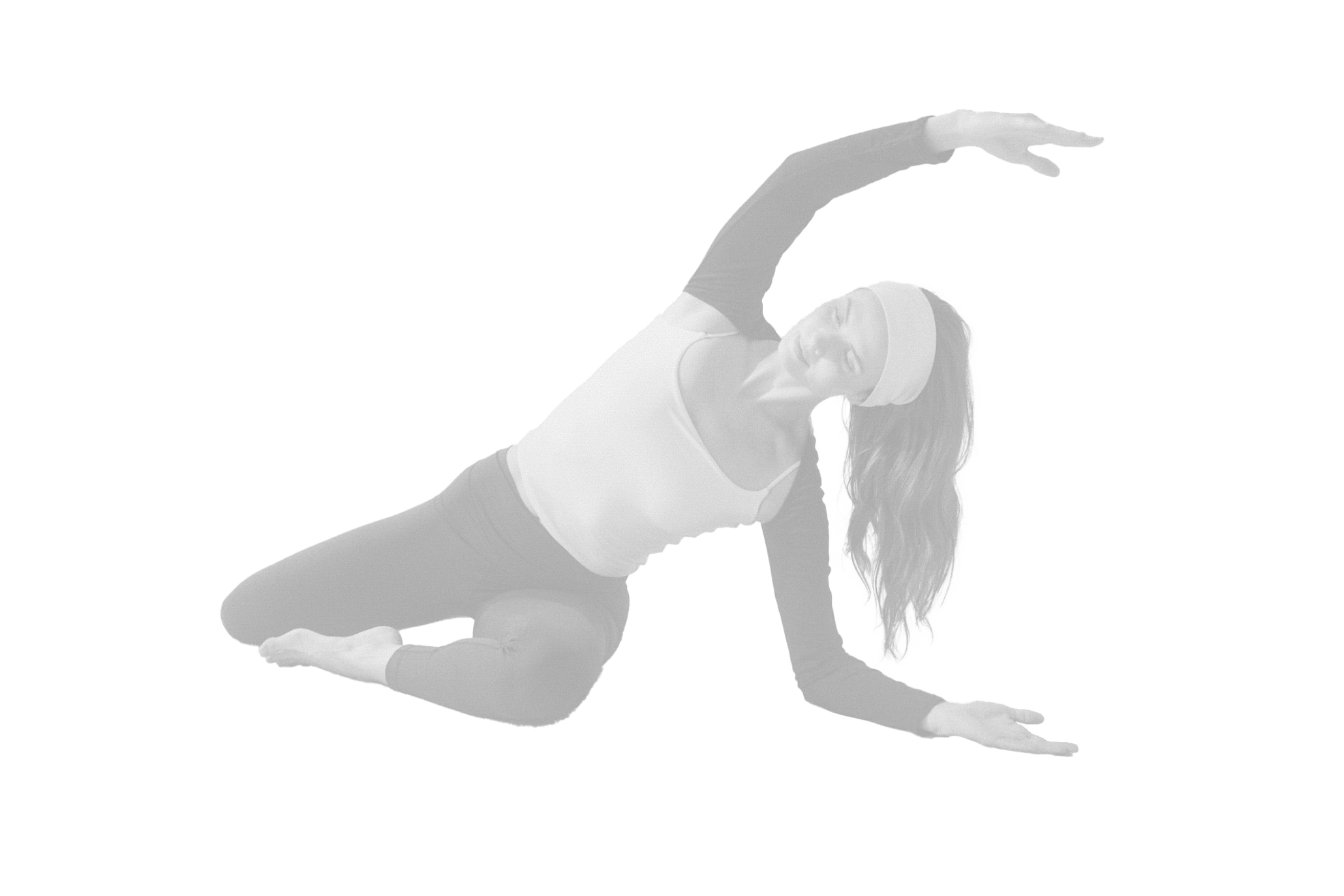Woman in athletic wear performing a side stretch yoga pose with eyes closed and headband on.
