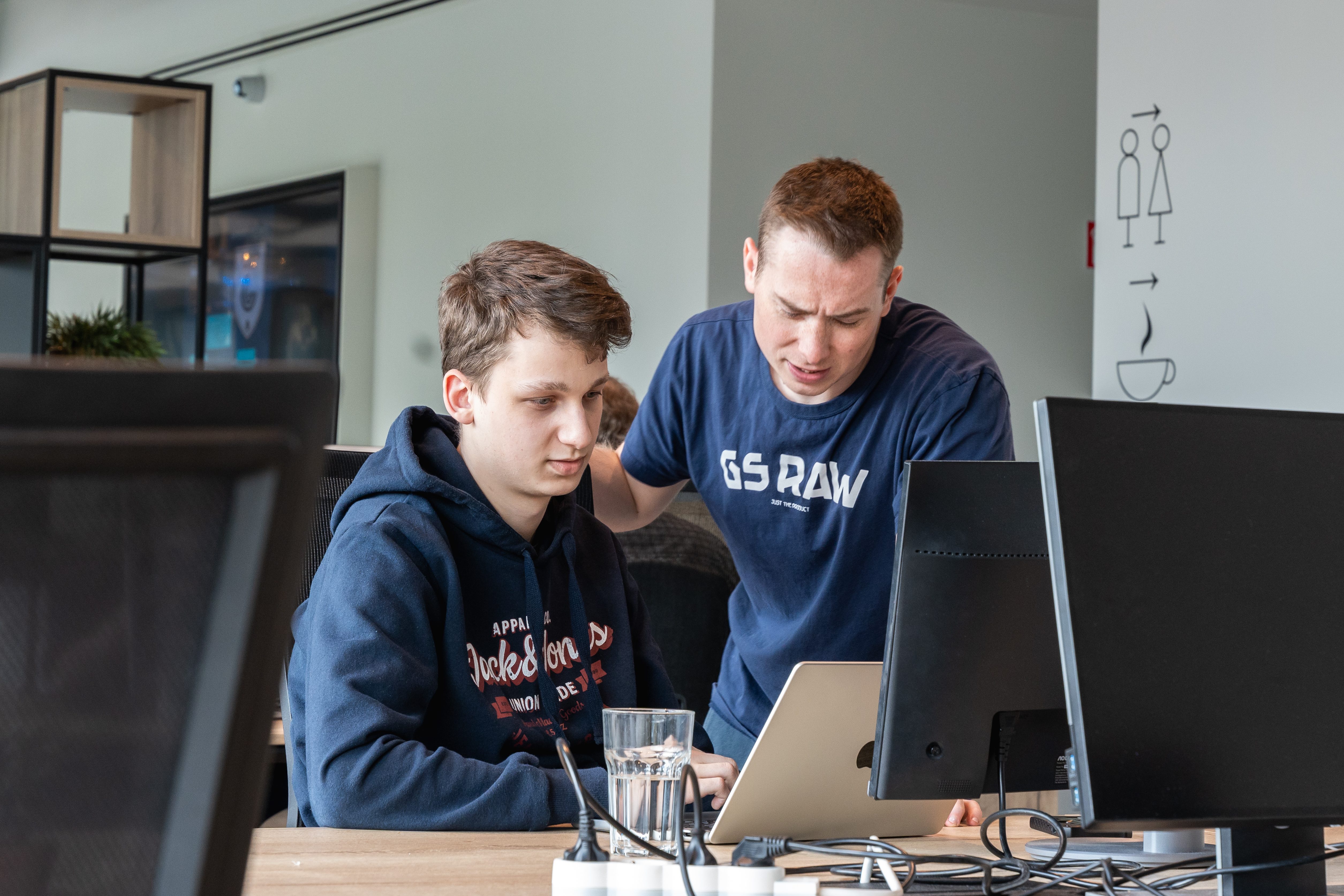 Two FlowFactor engineers working together at one screen