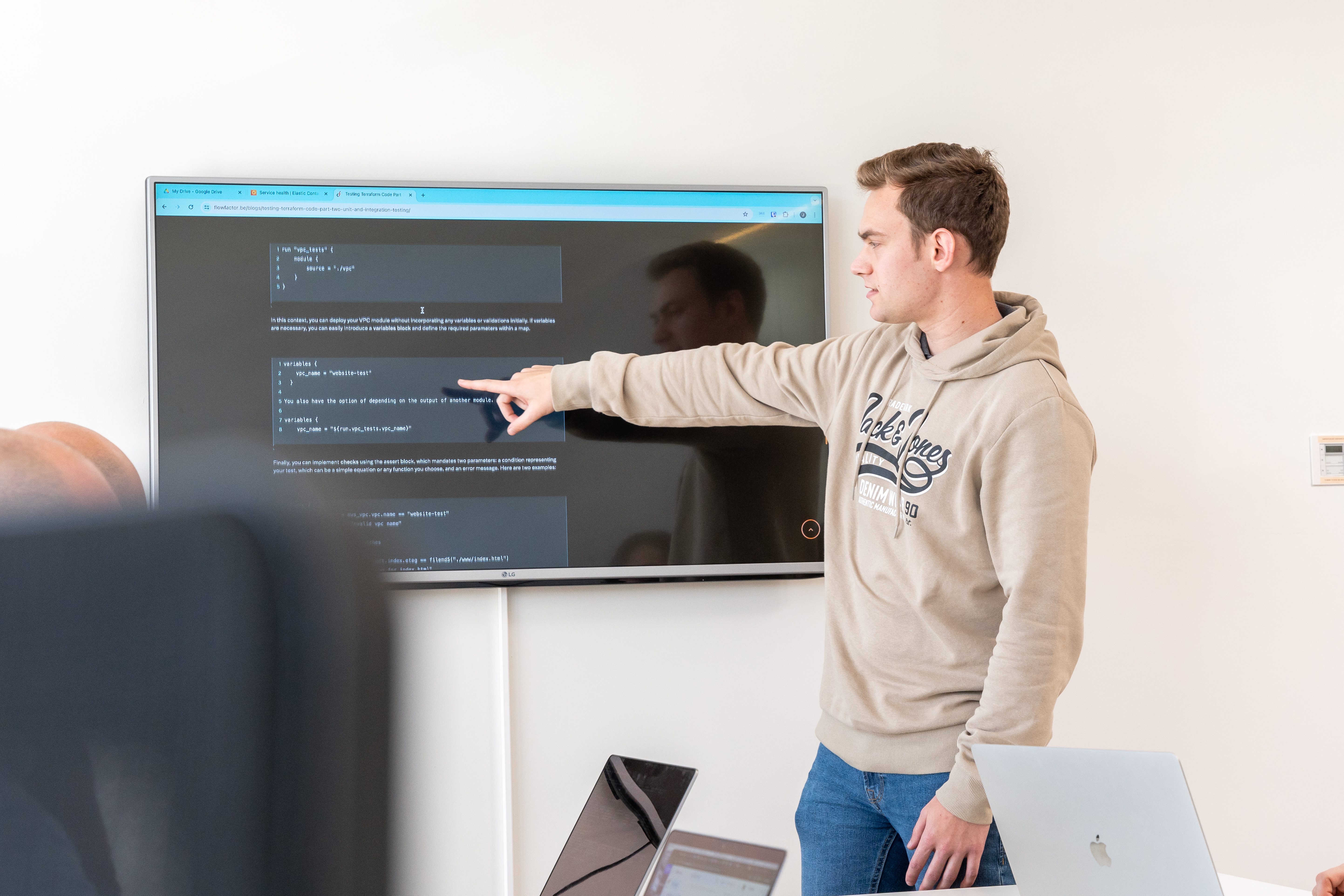 A FlowFactor engineer walks colleagues through code on a screen