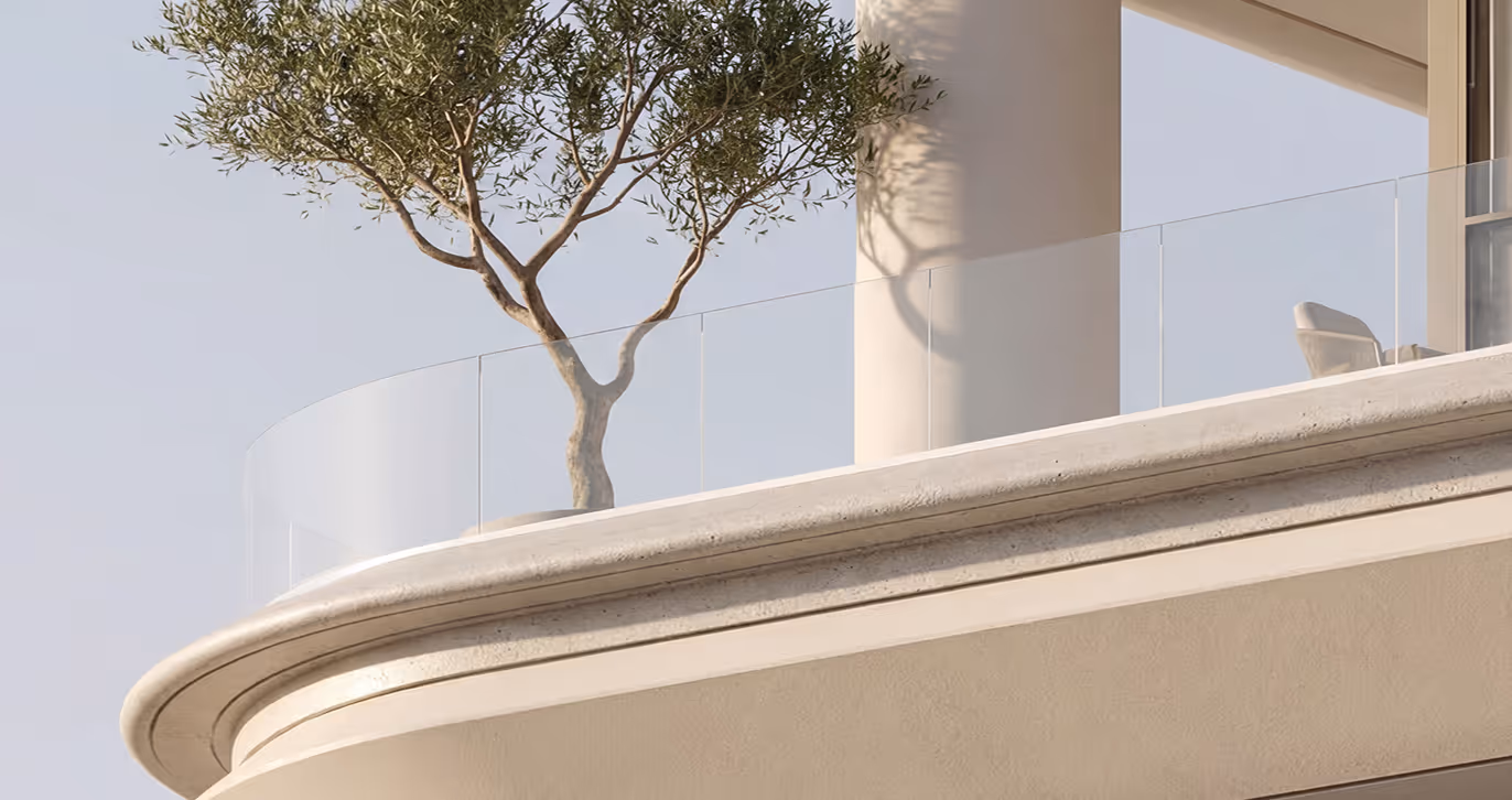 Modern balcony with clear glass railing featuring a small olive tree and outdoor chair under soft daylight.