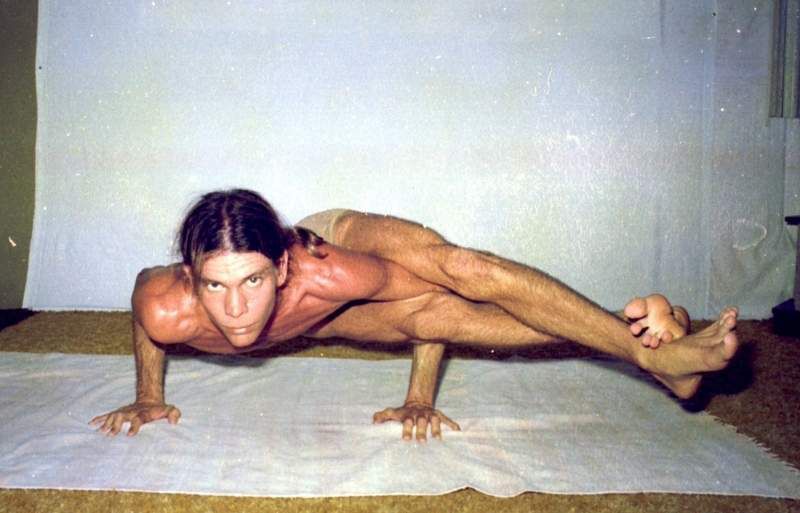 Bryan Kest seated in profile view with hands in prayer position and eyes closed, embodying deep meditative focus