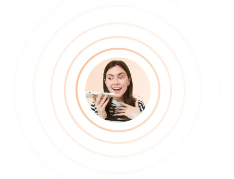 Young woman holding a smartphone and speaking into it with a smile, surrounded by concentric orange circles.