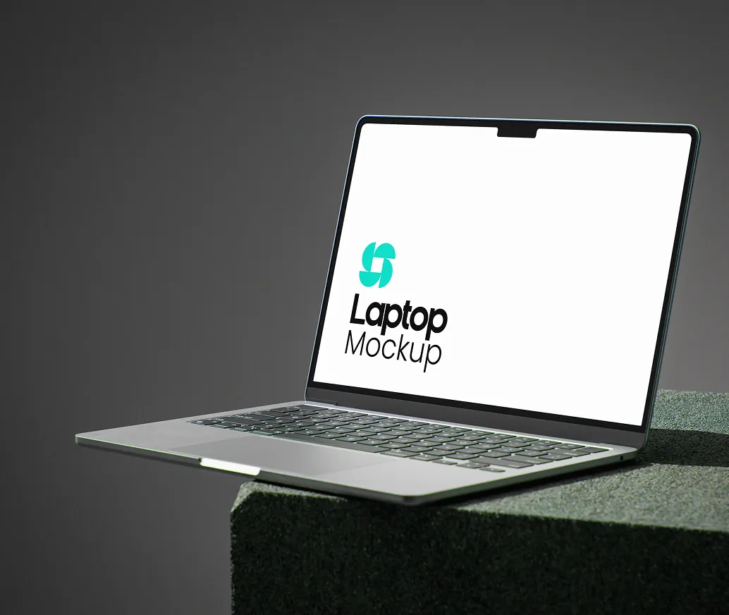Sleek laptop with thin bezels on a dark surface displaying the text 'Laptop Mockup' on screen.