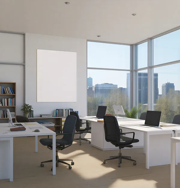 Modern office space with white desks, black swivel chairs, laptops, and a cityscape visible through large windows.