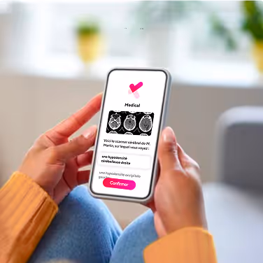 Person holding smartphone displaying medical brain scan images with confirmation button.