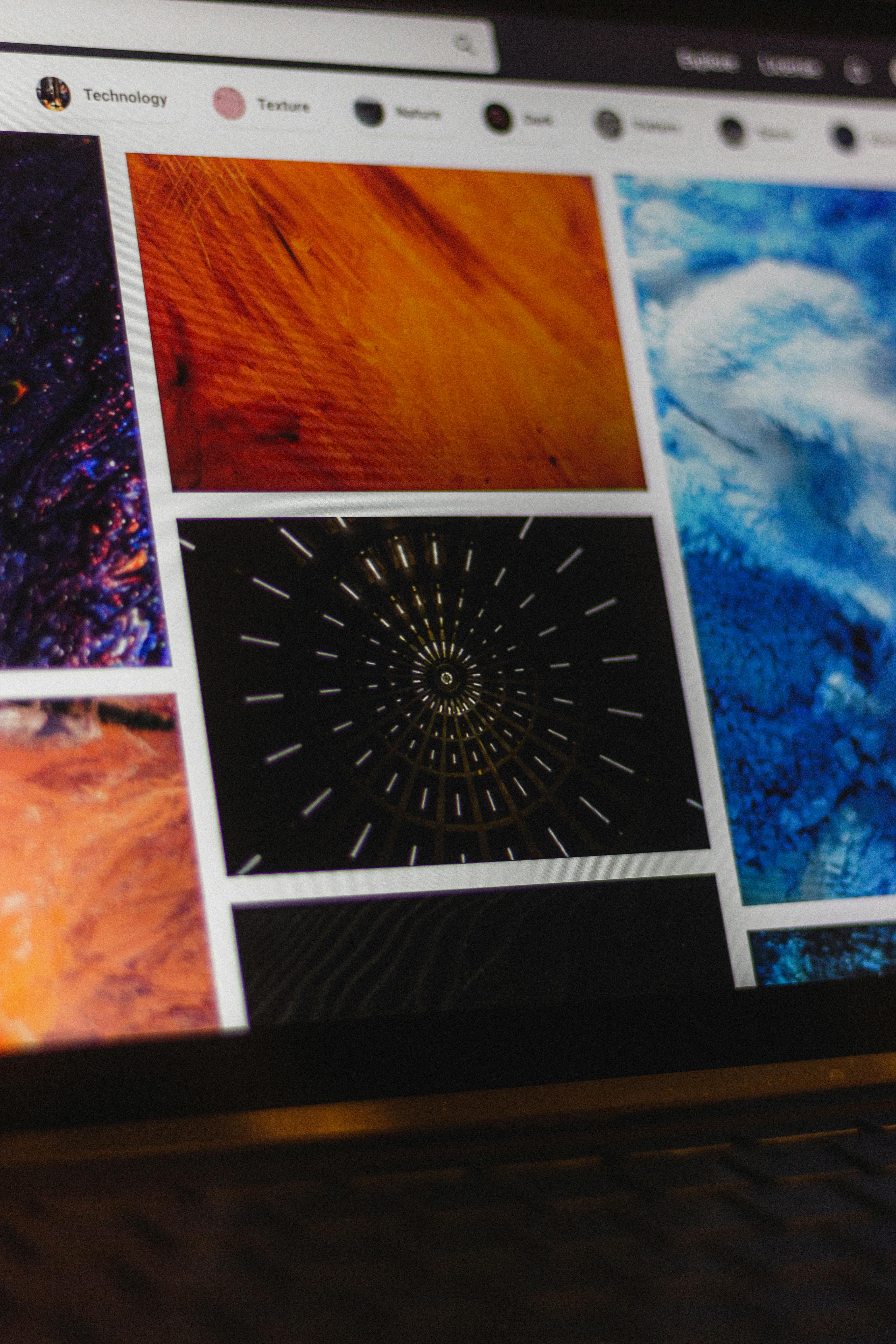 Computer screen displaying an image gallery with categories like Technology and Texture, showing abstract colorful images in orange, blue, and black tones.
