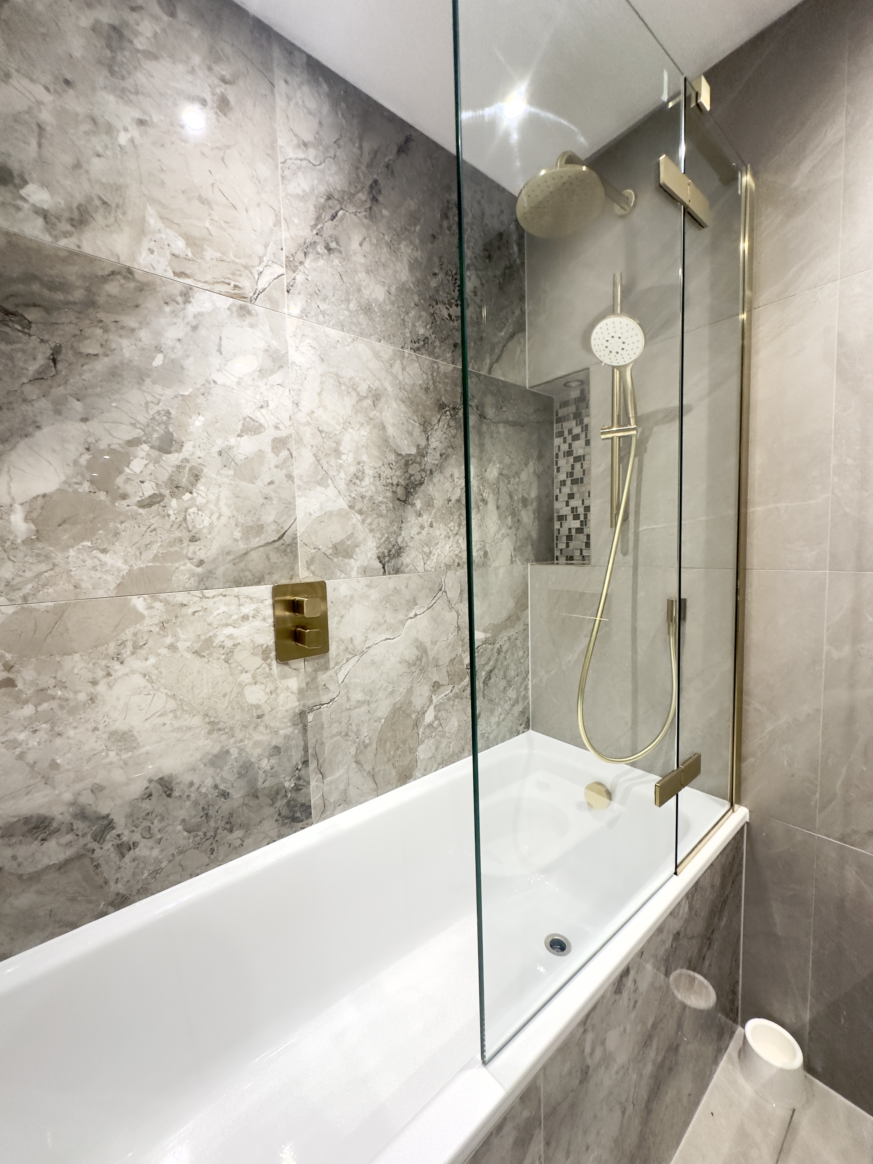 Luxury London bathroom with brushed gold fittings professionally cleaned by Tidy Hub