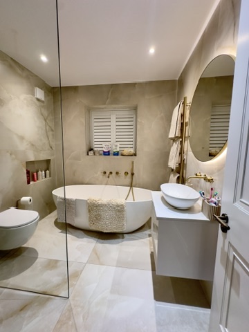 Bathroom finished after post-renovation clean, marble and gold fittings