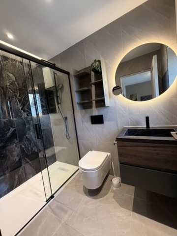 Marble bathroom with gold vanity mirror cleaned by Tidy Hub