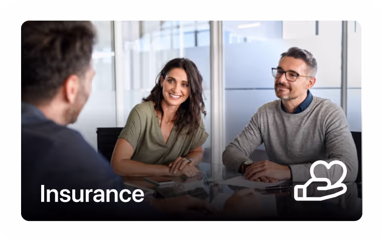 Three people having a business meeting in an office, with the word Insurance and a heart in hand icon.